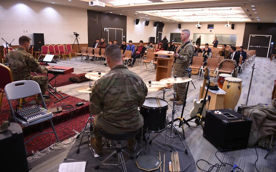 1st. Lt. Philip Tappan, Staff Sgt. Daniel Madsen and Sgt Wesley Wagner, of the U.S. Forces Afghanistan Band, demonstrate how to play a jazz piece. The lesson was part of a three-day conference with students and instructors from Kabul University's music program at the U.S. Embassy in Kabul, Wednesday, Jan. 25, 2017.
