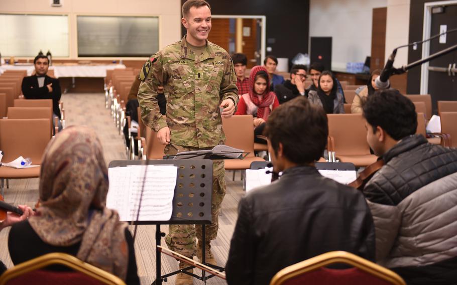 U.S. Army 1st. Lt. Philip Tappan, of the U.S. Forces Afghanistan Band, leads a rehearsal for a joint concert with music students and instructors from Kabul University at the U.S. Embassy in Kabul, Wednesday, Jan. 25, 2017.