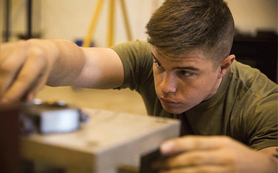 Cpl. Matthew A. Long checks connecting rods for the crank shaft of a High Mobility Multipurpose Wheeled Vehicle, Nov. 8, 2016, at Camp Kinser, Okinawa, Japan. Marines took apart, cleaned, and assembled an engine of a HMMWV. Long, a Moultrie, Georgia native, is an automotive maintenance technician with 3rd Marine Logistics Group, III Marine Expeditionary Force. (U.S. Marine Corps photo by Cpl. Nathaniel Cray / Released)