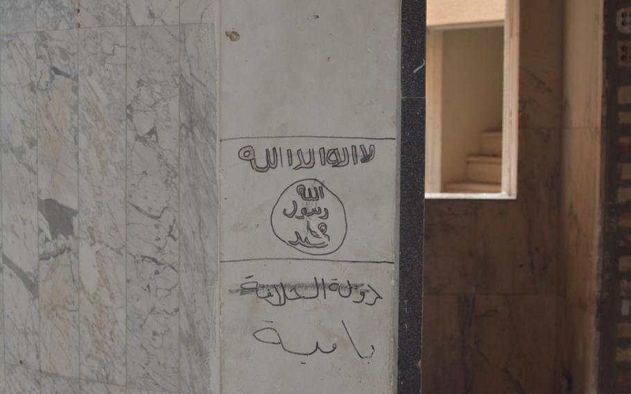 The Islamic State flag is drawn inside a palace overlooking the Tigris River in Mosul, Iraq, that once served as Gen. David Petraeus' headquarters.