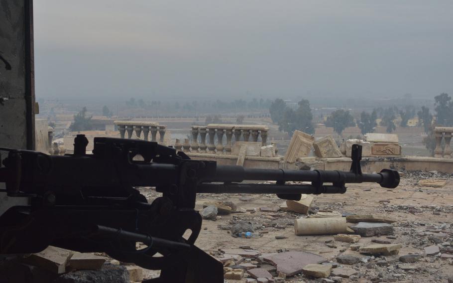 A machine gun points toward the Tigris River from a palace in Mosul, Iraq, on Wednesday, Jan. 25, 2017.
