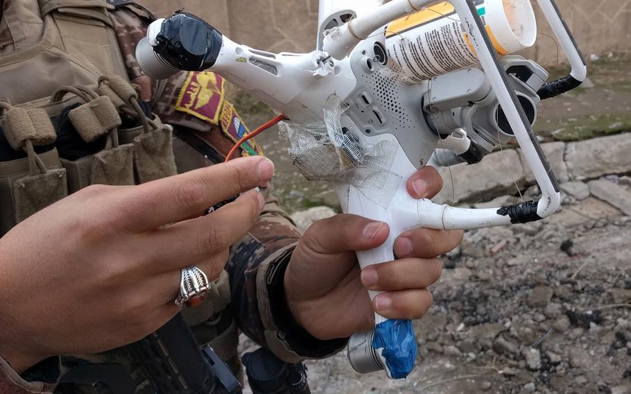 An Iraqi Counter Terrorism Service soldier in Mosul, Iraq, examines a quadcopter, modified by the Islamic State group to carry a 40 mm rifle grenade. Insurgent groups in Iraq started using handheld drones for surveillance two years ago. Now many of them have figured out how to arm them to attack adversaries.