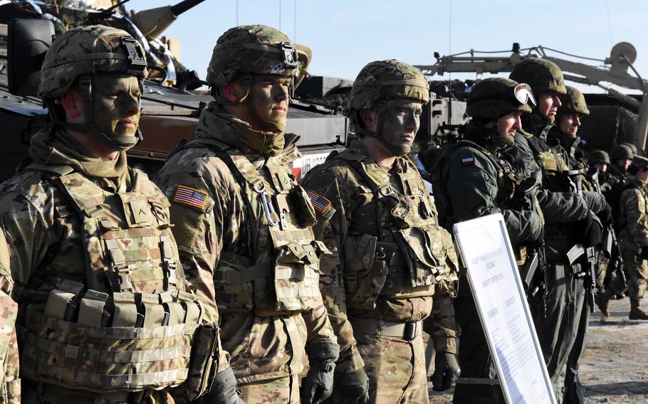 American and Polish soldiers in front of their vehicles at the live fire exercise in Zagan, Poland, on Monday, Jan. 30, 2017.