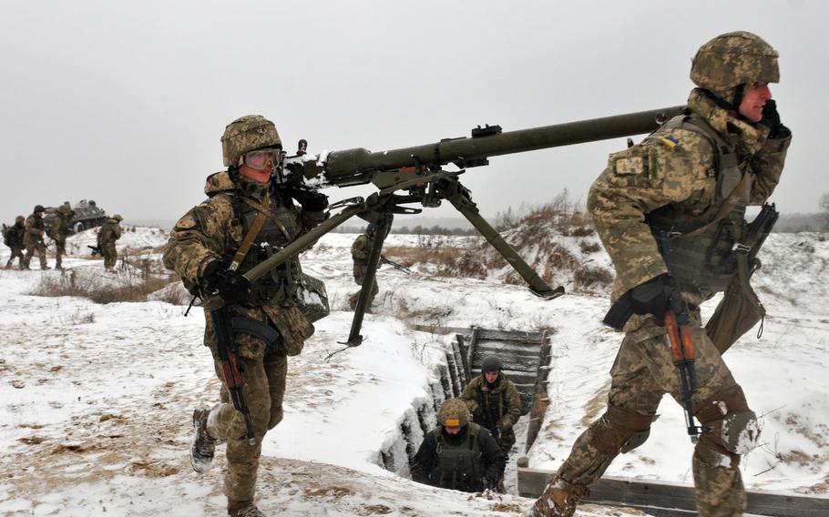 Ukrainian soldiers carry a recoilless rifle during a training exercise led by troops from the 2nd Infantry Brigade Combat Team, 3rd Infantry Division, in November 2016 at a range near Yavoriv, Ukraine.