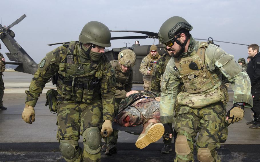 Czech soldiers carry a stretcher-borne casualty off of a UH-60 Blackhawk helicopter during an international combat lifesaver course on Thursday, Feb. 2, 2017, at Clay Kaserne in Wiesbaden, Germany. Troops from Austria, Germany, the U.S., Finland and Britain also participated.