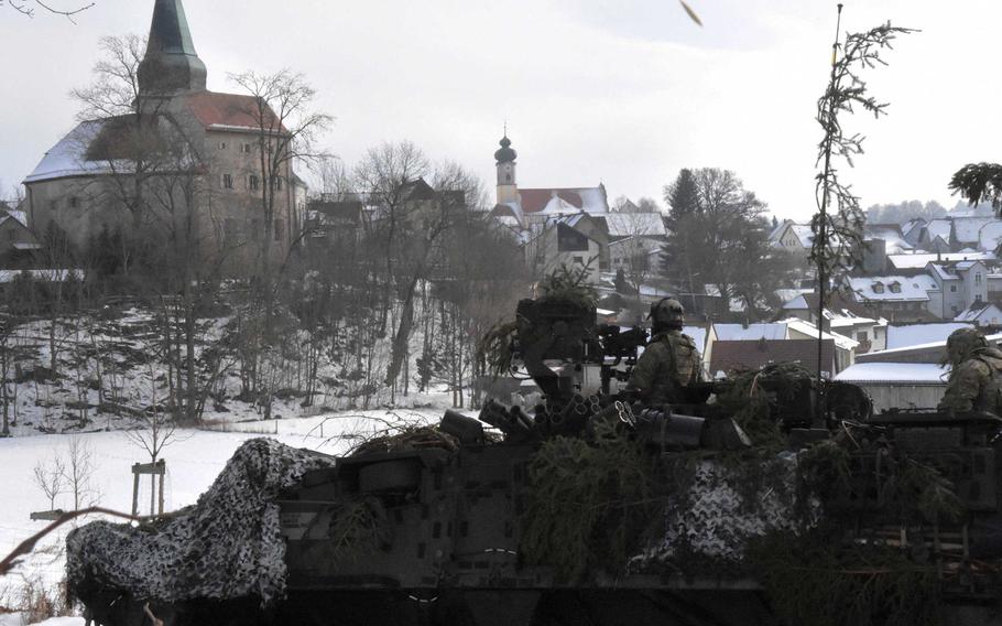 Army scouts travel past a German village during training that took them off post to deal with hybrid enemies, Thursday, Feb. 2, 2017.