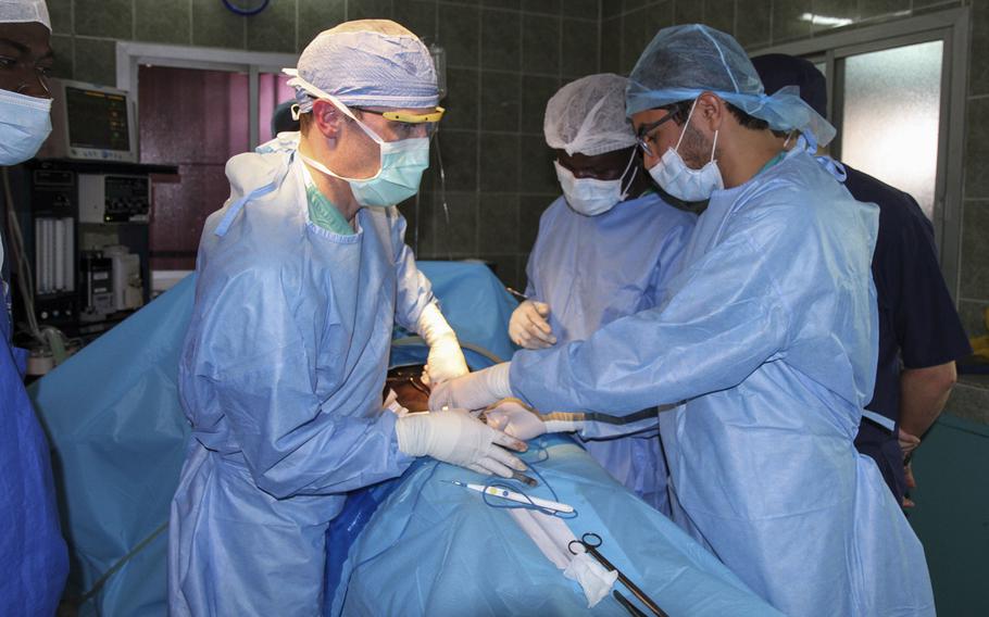 Maj. Anthony Donaldson, a urologist from the Vermont Air National Guard, Senegalese urologist Dr. Niang, and a Moroccan intern conduct surgery during Medical Readiness Training Exercise in Dakar, Senegal, Jan. 18, 2017. MEDRETE is a joint effort by the Senegalese government and the U.S. military.