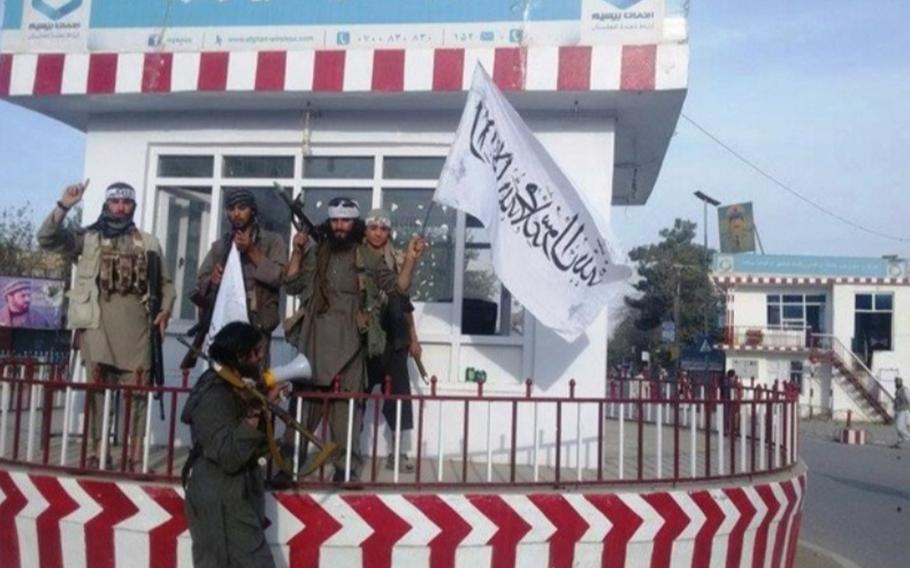 In an image released by a Taliban spokesman on Twitter, militants display their flag at the center of Kunduz, Afghanistan, when they briefly captured the city in the fall of 2015.
