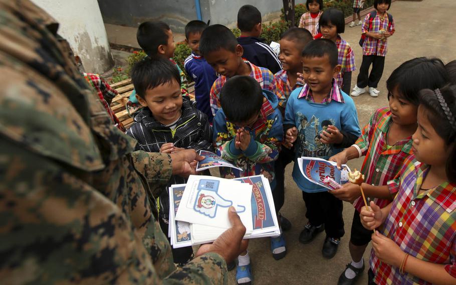 Students receive Cobra Gold stickers and coloring books at Ban Nong Mee, Buri Ram Province, Thailand, Feb. 3, 2017. The exercise, one of the world's largest multinational military events, kicked off Tuesday, Feb. 14, 2017.