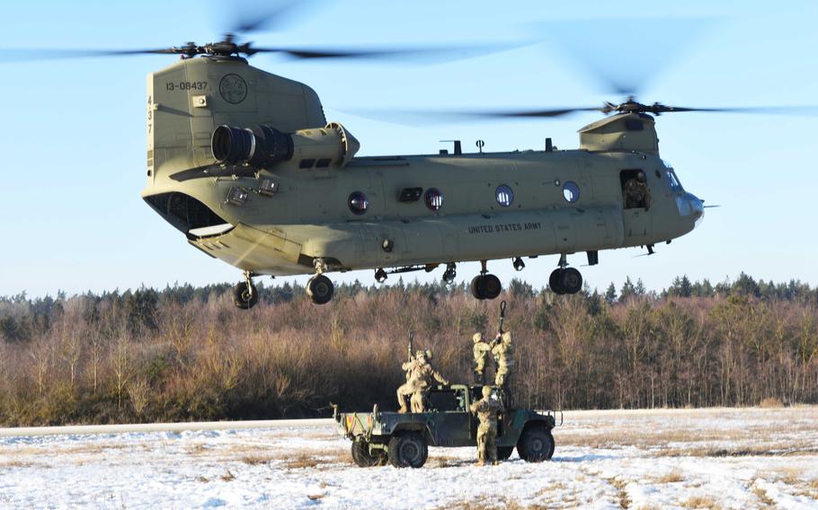 U.S. Army soldiers attending the Pathfinder course in Grafenwoehr, Germany, attach a Humvee to a CH-47 Chinook with a sling load, Tuesday, Feb. 14, 2017.
