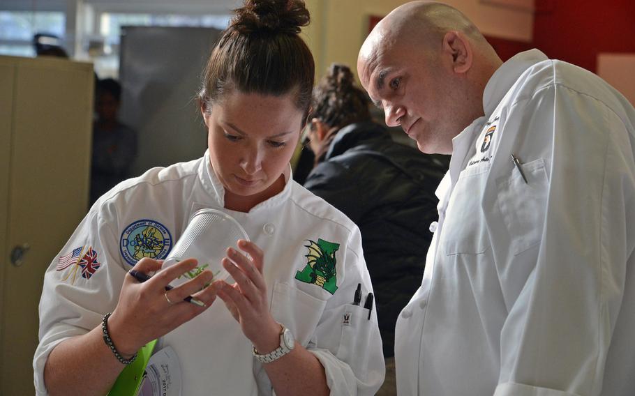 Judges Karri Selby and Joseph Wisniewski check out Wiesbaden's chiffonade cuts  at the DODEA-Europe Culinary Arts Championships in Kaiserslautern, Germany, Wednesday, Feb. 15, 2017. Each team needed to perform four different cuts during the competition.