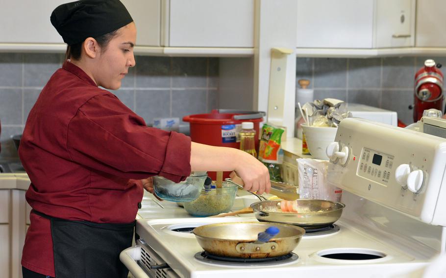 Vilseck's Aileen Garibay fries shrimp for the creamy mushroom and shrimp pasta dish her team cooked at the DODEA-Europe Culinary Arts Championships in Kaiserslautern, Germany, Wednesday, Feb. 15, 2017.