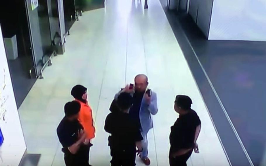 This image from CCTV footage taken Feb, 13, 2017, at Kuala Lumpur International Airport in Malaysia shows Kim Jong Nam explaining the attack to airport staff shortly before his death.