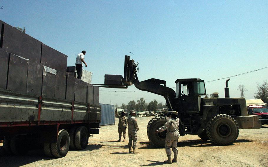 Soldiers from 94th Engineer Combat Battalion (Heavy) unload lockers from a truck at Forward Operating Base Marez, Iraq, in August 2005. The base was next to Mosul airport, which was liberated from the Islamic State group on Saturday, Feb. 25, 2017.