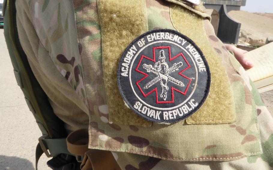 A volunteer medic near the front lines of the battle for Mosul, Iraq, wears the patch of the Slovak charity Academy of Emergency Medicine on Tuesday, Feb. 28, 2017. Medics, including several military veterans from the United States and Europe, are working with the charity to treat casualties in an area where medical services are limited.