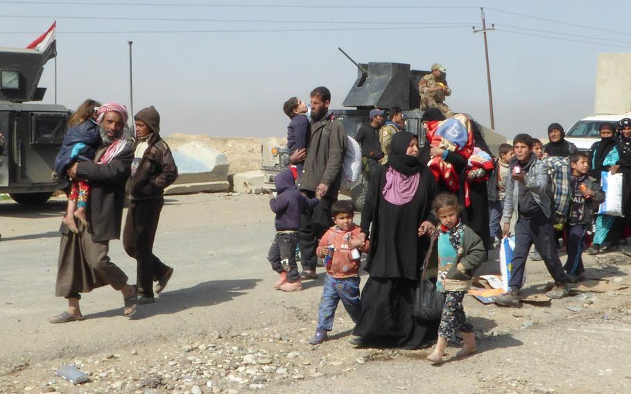 Pictured here are some of the roughly 100 Iraqi civilians who fled Mosul on the Mosul-Baghdad Highway on Tuesday, Feb. 28, 2017, after Iraqi army Counter Terrorism Service troops opened the road and began an attempt to advance on the Mosul neighborhood of Wadi Hajar.