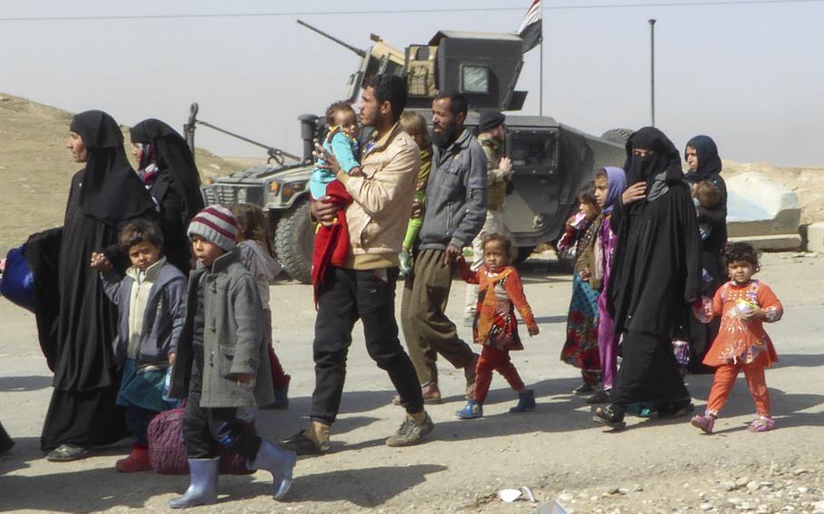 Pictured here are some of the roughly 100 Iraqi civilians who fled Mosul on the Mosul-Baghdad Highway on Tuesday, Feb. 28, 2017, as Iraqi troops prepared to advance on the Mosul neighborhood of Wadi Hajar. About 10,000 civilians have been displaced since fighting began in western Mosul on Feb. 19, in addition to more than 200,000 displaced when the offensive began in eastern Mosul on Oct. 17, 2016.