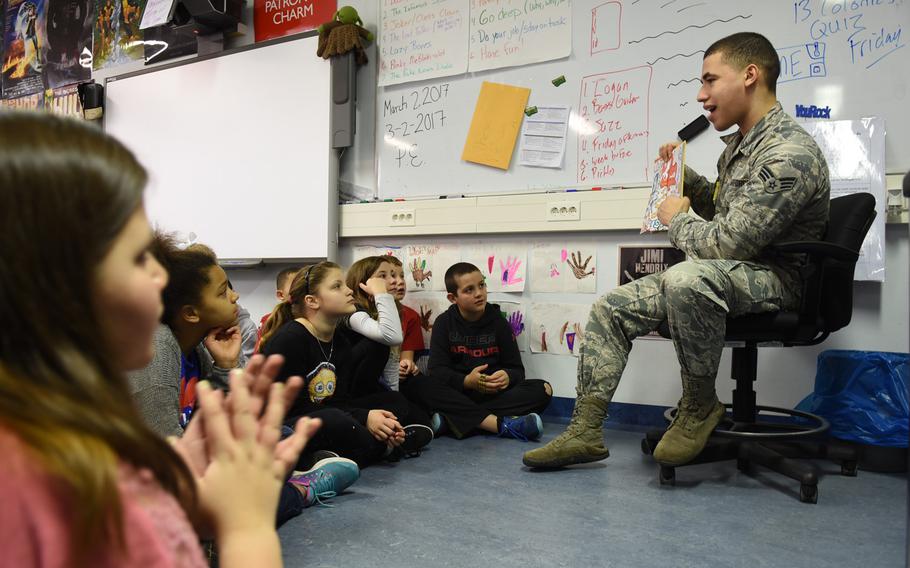 Senior Airman Royer Figuereo reads Dr. Seuss' "Did I Ever Tell You How Lucky You Are?" to fifth-graders at Ramstein Intermediate School in Germany on Thursday, March 2, 2017.