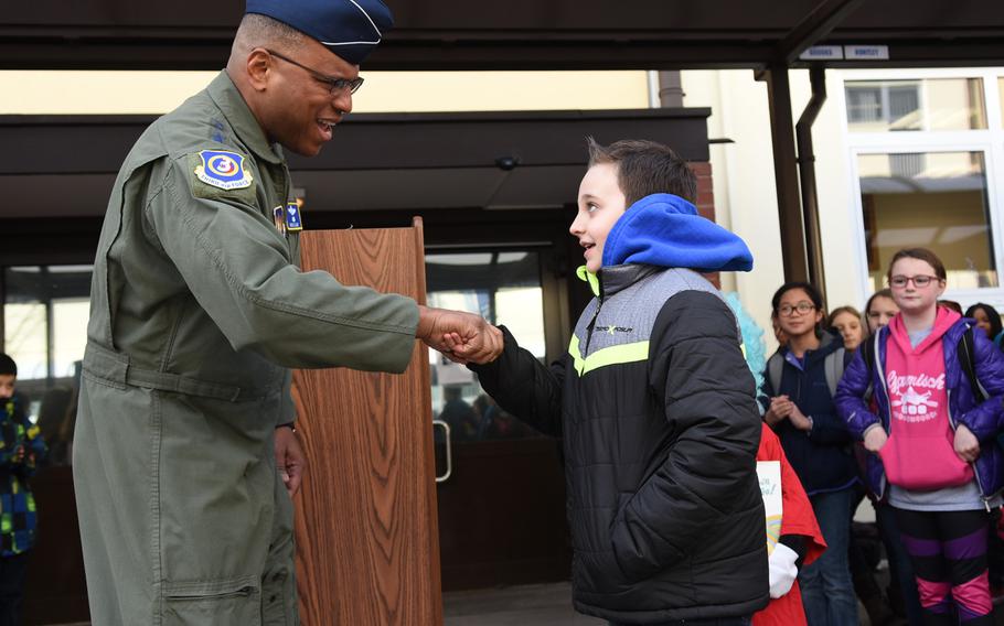 Lt. Gen. Richard Clark shakes hands with Ramstein Intermediate School, Germany, fifth-grader Skylar Murray on Thursday, March 2, 2017. Clark slipped him a military coin for being one of his school's most prolific readers.