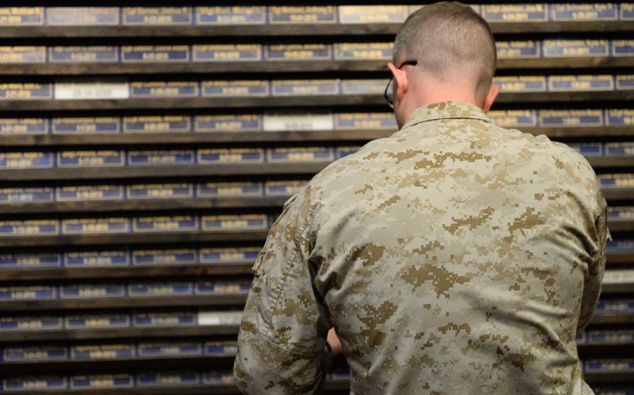 A Marine reflects at a new memorial to Marines and Navy corpsmen killed in Afghanistan at the U.S. Embassy in Kabul on Thursday, March 2, 2017.