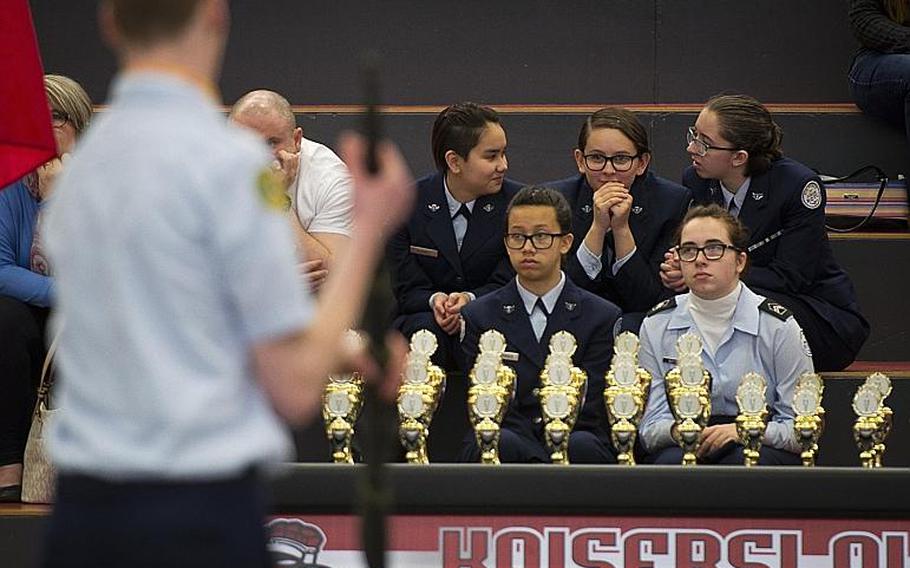Cadets watch SHAPE's drill team perform in the armed team rifle exhibition during the DODEA-Europe JROTC drill team championships in Kaiserslautern, Germany, on Saturday, March 4, 2017. SHAPE won the event.