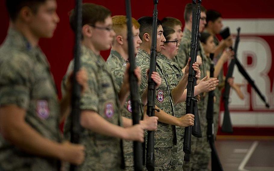 Members of Lakenheath's drill team competes in the armed team rifle exhibition during the DODEA-Europe JROTC drill team championships in Kaiserslautern, Germany, on Saturday, March 4, 2017. Lakenheath won second place in the event.