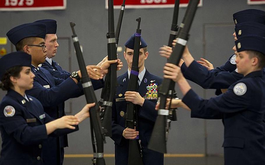 Members of Bitburg's drill team compete in the armed team rifle exhibition during the DODEA-Europe JROTC drill team championships in Kaiserslautern, Germany, on Saturday, March 4, 2017.