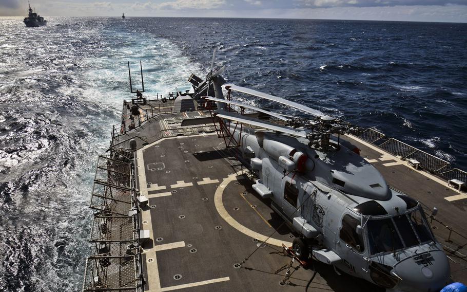 An MH-60R Seahawk helicopter, embarked aboard Standing NATO Maritime Group 2 flagship USS Vicksburg, sits on the ship's flight deck during an underway replenishment in the Atlantic Ocean in April 2015.