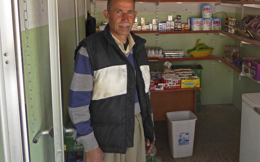 Khiri Elias, a Yazidi man pictured here runs a small shop in Bashiqa, Iraq, Monday, March 6, 2017,  He said one of his most popular products is alcohol, including arak, an anis-flavored liquor the village was once known to produce.