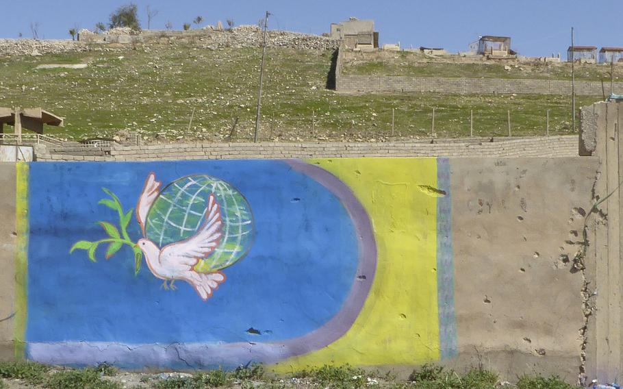 A recently painted mural of a dove on a wall in Bashiqa, Iraq, Monday, March 6, 2017. The village was liberated from the Islamic State group in November. Before the militants swept in, the village was considered one of the country's more peaceful areas.