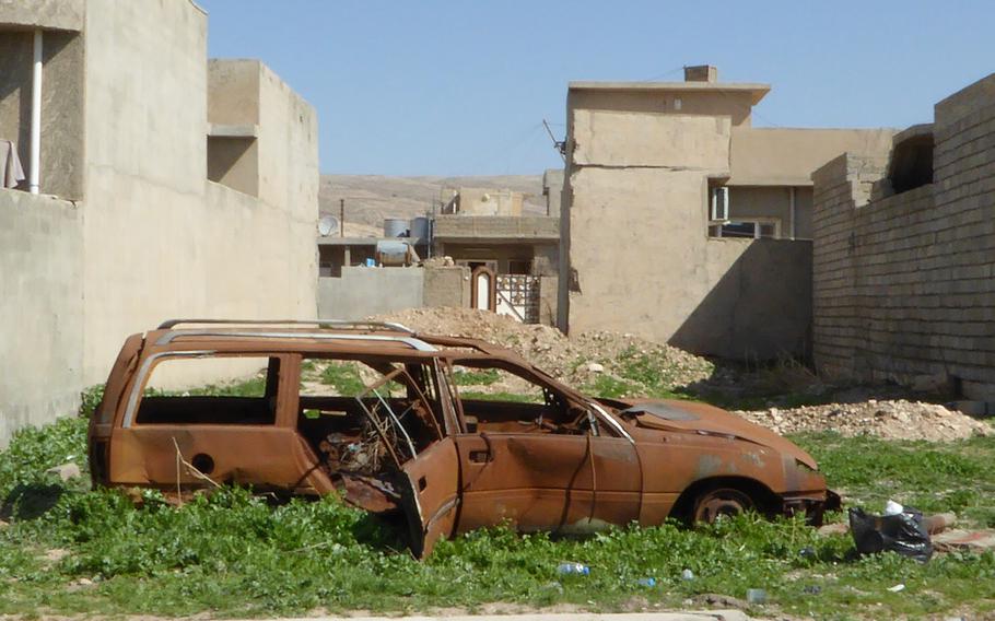 A rusted station wagon sits among the weeds in Bashiqa, Iraq, pictured here on Monday, March 6, 2017.