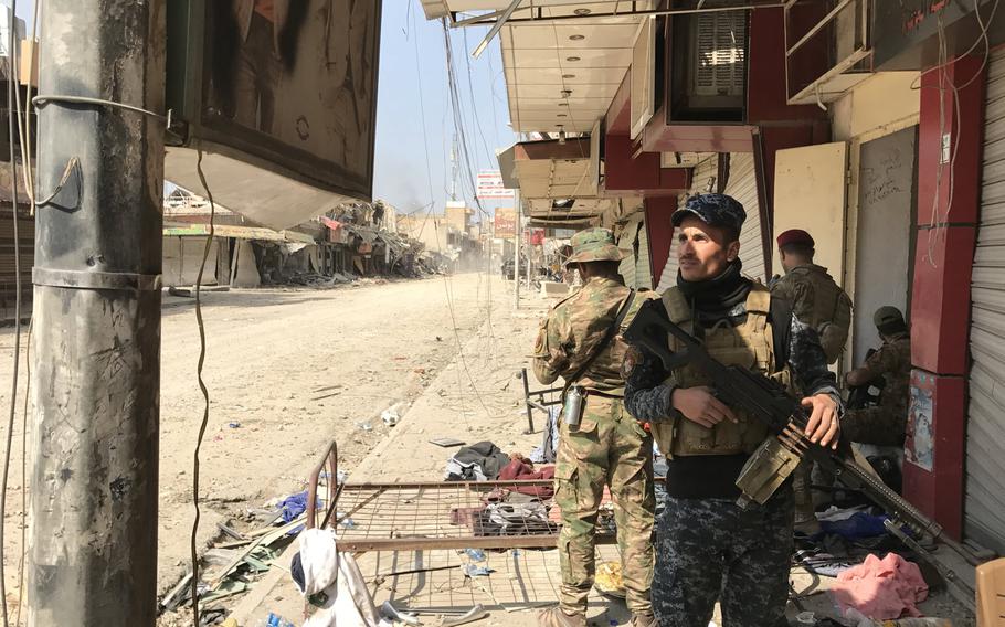 An Iraqi federal police officer stands watch on a street in central Mosul on Wednesday, March 8, 2017. The police and a special operations unit called the emergency response division were working to clear western Mosul neighborhoods close to the Tigris River, while other Iraqi forces were fighting Islamic State farther to the west.
