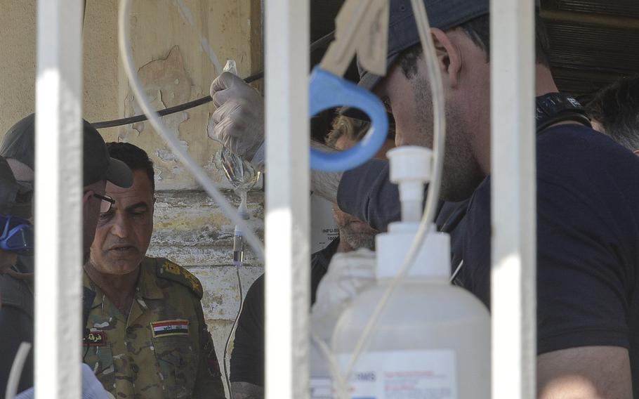 Iraqi emergency-response division Brig. Gen. Abbas al-Jabouri speaks with American medics at a field clinic in western Mosul on Thursday, March 9, 2017. Jabouri said his forces reclaimed a government complex from Islamic State fighters in western Mosul with the help of American advisers.
