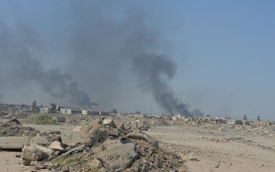 Columns of smoke rise from western Mosul, north of the city's airport, on Thursday, March 9, 2017. Islamic State fighters use the smoke to ward off airstrikes and surveillance aircraft as they fight to repel Iraqi forces closing in on their positions in the city, Iraq's second largest and the Islamist group's last major stronghold in the country.