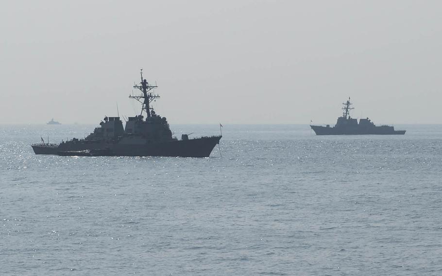 The guided-missile destroyers USS Curtis Wilbur, left, and USS Mustin are anchored off the Korean coast in October 2015.
