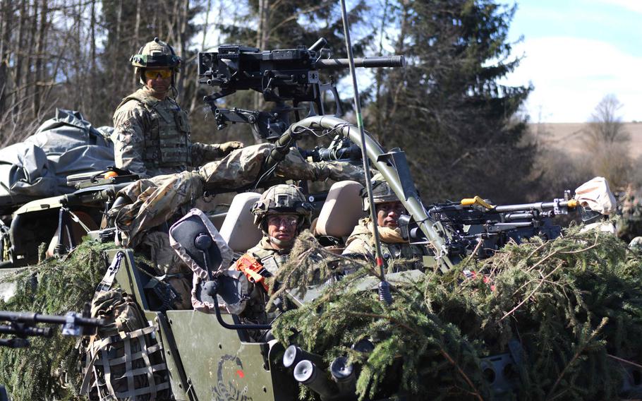 British reconnaissance soldiers surveying an area as part of their training with the American 2nd Cavalry Regiment in preparation for their upcoming rotation to Poland.