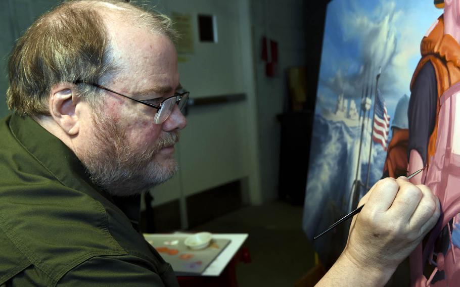 Morgan Wilbur, an artist with the Navy's Combat Art Program, paints a scene from his 2014 deployment aboard the guided-missile destroyer USS Mustin, Dec. 28, 2016.