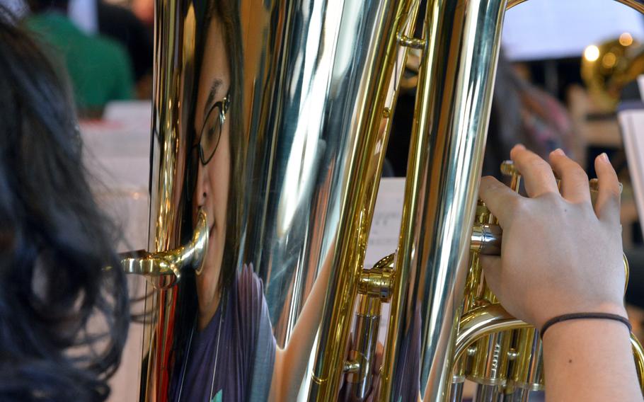 Vicenza's Derek Hammond is reflected in his tuba as he rehearses a song with the band at the DODEA-Europe Honors Music Festival, Tuesday, March 14, 2017.