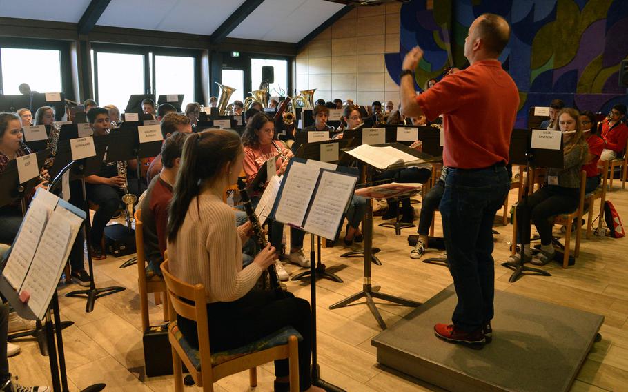 Don Schofield Jr. conducts the honors band as they rehearse a number at the DODEA-Europe Honors Music Festival, Tuesday, March 14, 2017.