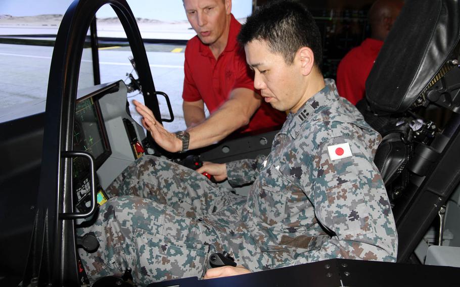 A member of the Japan Self-Defense Forces tries out an F-35 fighter-jet simulator during a two-day symposium at Joint Base Pearl Harbor-Hickam, Hawaii, Tuesday, March 14, 2017.