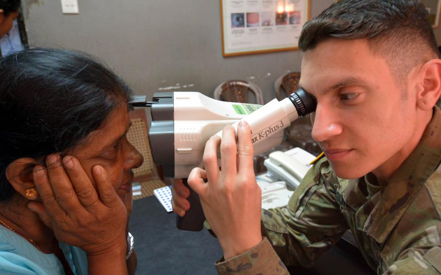 Sgt. Jorge Laguna-Ramos examines a patient's eyes at a hospital in Hambantota, Sri Lanka, March 8, 2017. Ramos and health care providers from the Army and Navy saw hundreds of patients as part of Pacific Partnership 2017, a three-nation humanitarian exercise.