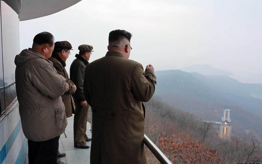 North Korean leader Kim Jong Un, far right, observes a rocket-engine test in this undated photo from the Korean Centreal News Agency.
