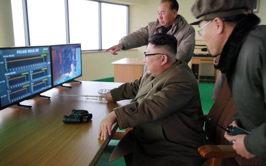 North Korean leader Kim Jong Un, seated, observes a rocket-engine test in this undated photo from the Korean Centreal News Agency.