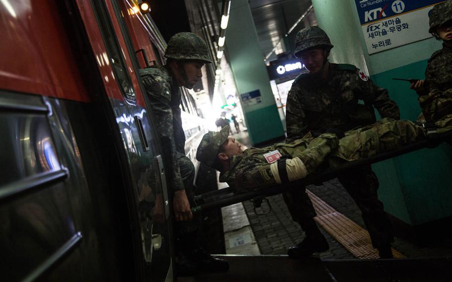 South Korean medics evacuate a simulated U.S. Army casualty at a train station in Suwon, South Korea, Wednesday, March 15, 2017.