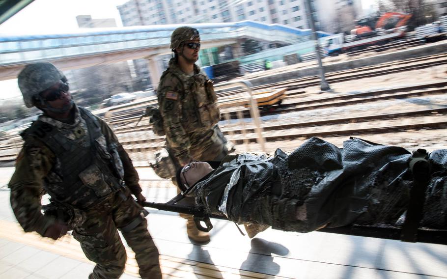 American soldiers rush a simulated casualty to a medical train in Seoul, South Korea, Wednesday, March 15, 2017.