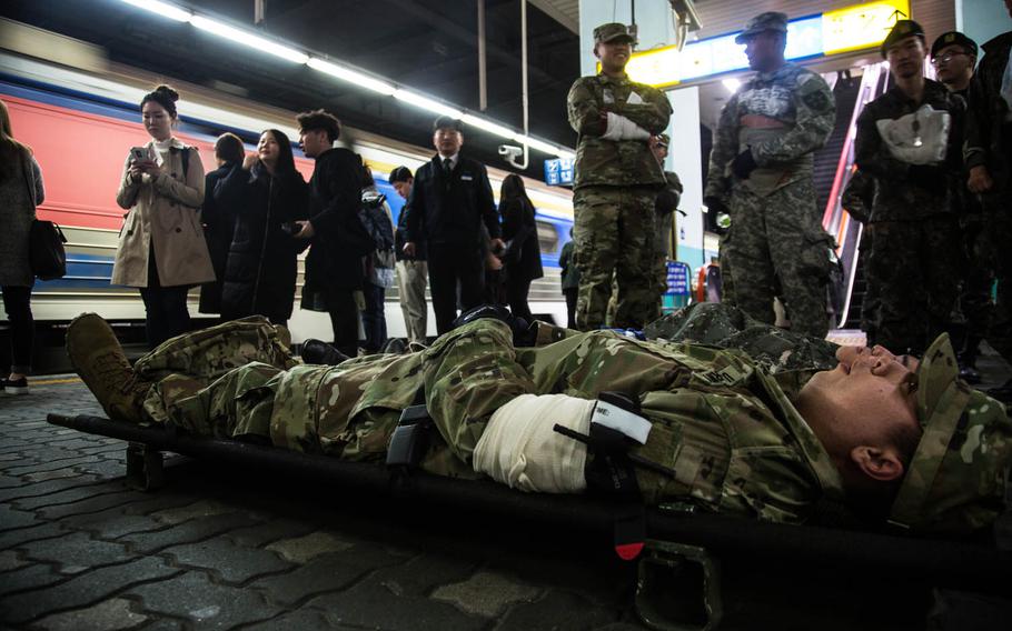 Simulated casualties wait to be evacuated during a drill Wednesday, March 15, 2017, in South Korea.