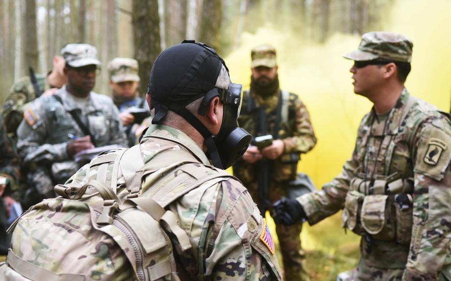 Instructors at the Expert Field Medical Badge training explain decontamination procedures for chemical warfare to the candidates. More than 200 candidates registered for the course, but fewer than 50 are anticipated to earn the badge.