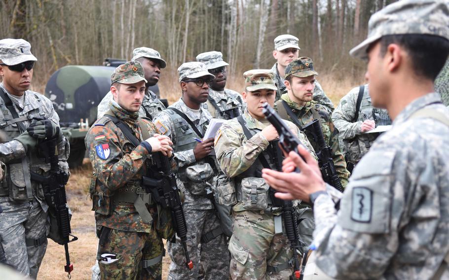 An instructor goes over the Beretta M9 pistol during the Expert Field Medical Badge training at Grafenwoehr, Germany, Monday, March 20. The candidates will need to know how to perform a function check on the pistol during the test, as it is standard issue for many combat medics.