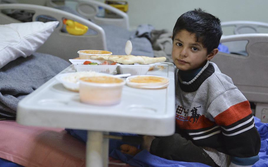 After being shot in the leg by an Islamic State sniper in his  neighborhood in western Mosul, Iraq, 6-year-old Tarek, pictured here eating lunch on March 11, 2017, was being treated at the U.S. Army Corps of Engineers-built West Irbil Emergency Hospital in the Kurdish region's capital. Civilians fleeing Mosul have become targets of the militant's violence. Those who stay are often used as human shields.