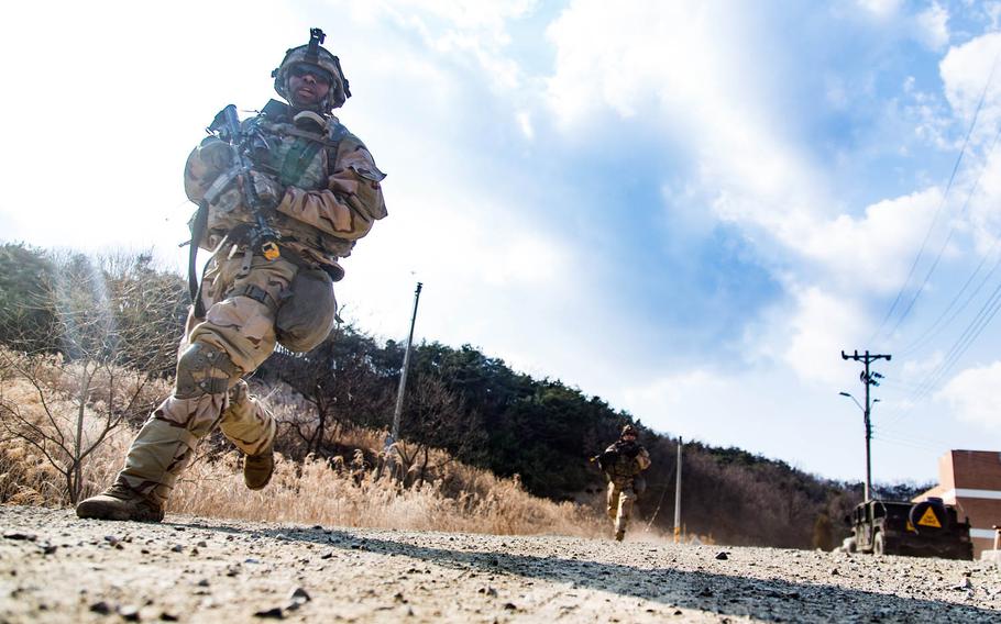Soldiers from the 1st Armored Brigade Combat Team, 1st Infantry Division storm a mock village during training at Rodriguez Live Fire Range in Paju, South Korea, Tuesday, March 21, 2017.